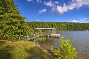 a dock in the middle of a body of water at Rogers Cabin with Direct Access to Beaver Lake! in Garfield