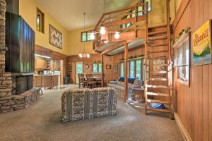 a living room with a spiral staircase in a house at Rogers Cabin with Direct Access to Beaver Lake! in Garfield