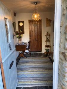 a hallway with a staircase with a wooden door at Bissick Old Mill Suite in Truro
