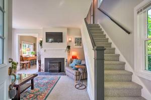 a living room with stairs and a fireplace at Lovely Lakewood Cottage Near Chautauqua Lake! in Lakewood