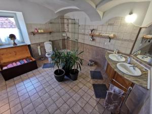 a large bathroom with two sinks and a shower at Charming village house with patio and garden in Slovenske Konjice