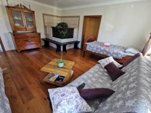 a living room with a couch and a table at Charming village house with patio and garden in Slovenske Konjice