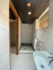 a bathroom with a sink and a shower at Big 5 Toro Lodge in Kasane