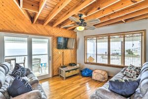 a living room with couches and a ceiling fan at Secluded Beachfront Gem on Alligator Point! in Sun N Sand Beaches