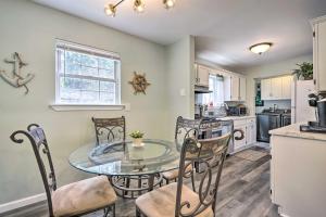 a kitchen and dining room with a glass table and chairs at Bayville Getaway with Fire Pit - 2 Mi to Beach! in Bayville
