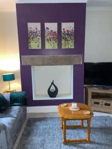 a living room with a couch and a coffee table at Selston House, 3 bedroom cosy cottage Home for up to 6 Guests, Cul-de-sac on Private road in Nottingham