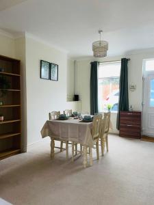 a dining room with a table and chairs at Selston House, 3 bedroom cosy cottage Home for up to 6 Guests, Cul-de-sac on Private road in Nottingham