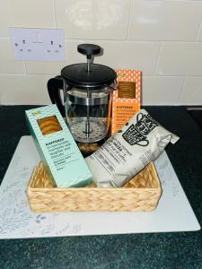a basket filled with food on a counter at Selston House, 3 bedroom cosy cottage Home for up to 6 Guests, Cul-de-sac on Private road in Nottingham
