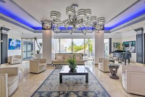 a living room with a chandelier and a piano at Oceanfront Luxury Renovated Resort Getaway! in Fort Lauderdale