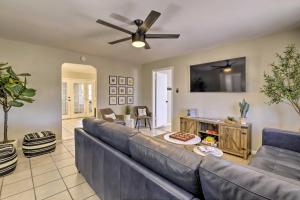 a living room with a couch and a ceiling fan at Pet-Friendly Peoria Home Patio, Grill and Foosball! in Peoria