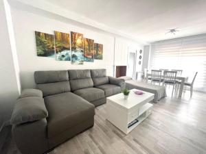 a living room with a couch and a table at Apartamento Vilagarcía de Arousa -Playa 7 - Rías Baixas in Vilagarcia de Arousa