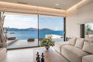 a living room with a view of the ocean at My Poros in Poros