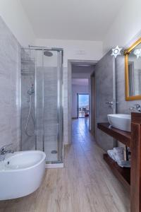 ein Badezimmer mit Badewanne und Dusche und zwei Waschbecken in der Unterkunft Casa Vacanze Il Vigneto in Castellabate + 32 Fotos