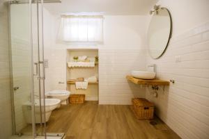 a bathroom with a toilet and a glass shower at Sweet House in Nocera Inferiore