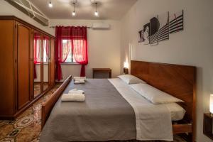 a bedroom with a large bed with two towels on it at La Valle di Hermes in Piraino