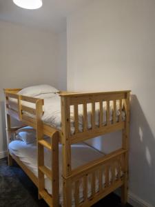 two bunk beds in a corner of a room at St Hilary Central Apartments in Llandudno
