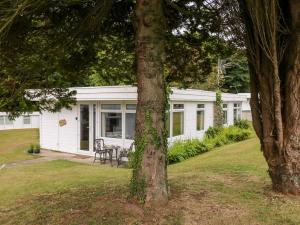 a white cottage with a table and chairs in a yard at Ty Haf in Haverfordwest