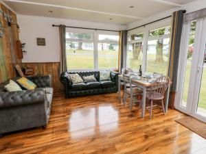 a living room with a table and chairs at Ty Haf in Haverfordwest +14 photos