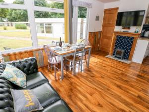 a living room with a table and a couch at Ty Haf in Haverfordwest