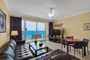 a living room with a couch and a table at Boardwalk 1405 in Panama City Beach