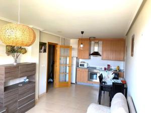 a kitchen with a couch and a table in a room at Barreiros Playa Altar in Barreiros