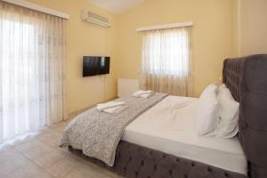 A bed or beds in a room at Villa with Private S Pool-Theologos by GHH Még 37 kép
