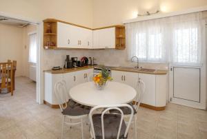 A kitchen or kitchenette at Villa with Private S Pool-Theologos by GHH