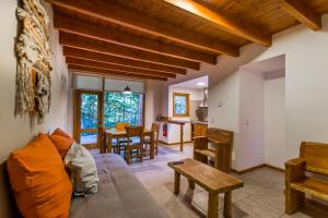 a living room with a couch and a table at Balcones del Sayhueque in Villa La Angostura