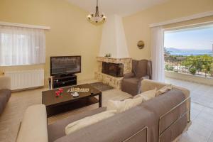 A seating area at Villa with Private S Pool-Theologos by GHH