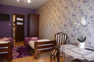 Posteľ alebo postele v izbe v ubytovaní Hotelik Pod Lwami