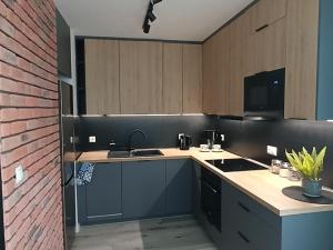 a kitchen with a sink and a counter top at Apartament Bernata-Śródka in Poznań