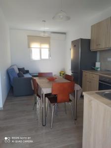 a kitchen and dining room with a table and chairs at Stegna Holiday in Archangelos