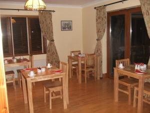 a dining room with wooden tables and chairs at Ethan House B&B in Rosscarbery