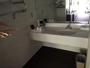 a bathroom with a sink and a mirror at Deerfield Inn in Somerville