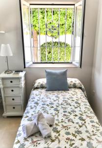 Кровать или кровати в номере Apartamento Las Flores