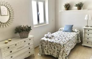 Łóżko lub łóżka w pokoju w obiekcie Apartamento Las Flores
