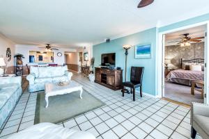 a living room with a couch and a bed at Shoreline Towers 3074 in Destin