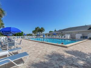 a large swimming pool with chairs and umbrellas at Shoreline Towers 3063 in Destin