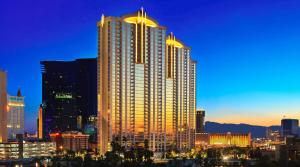 a large tall building in a city at night at Jet Luxury Elite at The Signature in Las Vegas