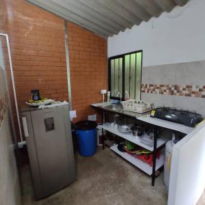 a kitchen with a counter and a table in a room at Cucú Ardilla Vivienda Campestre en Pance in Cali