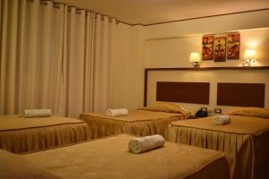 Ein Bett oder Betten in einem Zimmer der Unterkunft HOTEL AVENIDA