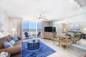 a living room with a couch and a dining room at Pelican Beach Resort 308 in Destin