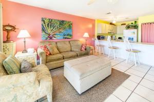 a living room with a couch and a kitchen at Island Sands 206 in Fort Walton Beach