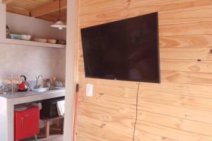 a flat screen tv on a wooden wall in a kitchen at El silencio - Lozano- Jujuy in San Salvador de Jujuy