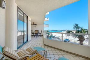 a balcony with chairs and a view of the beach at East Pass 207 in Destin
