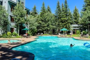 a pool at a hotel with people in the water at Ski-In Ski-Out Squaw Valley Lodge Slopeside Townhome in Olympic Valley