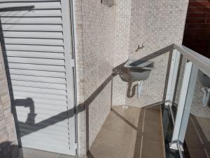 a bathroom with a sink in a brick wall at Apartamentos Margarida in Ubatuba +38 photos