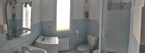 a bathroom with a white toilet and a sink at Loc'Eric in Pont-lʼAbbé