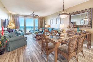 a living room with a table and chairs and a couch at Sterling Shores 818 in Destin
