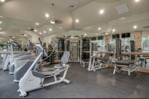 a gym with treadmills and machines in a room at Smoke free Amazing spacious 2 beds 2 baths modern living in Houston